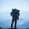 Man Traveler with backpack mountaineering Travel Lifestyle concept